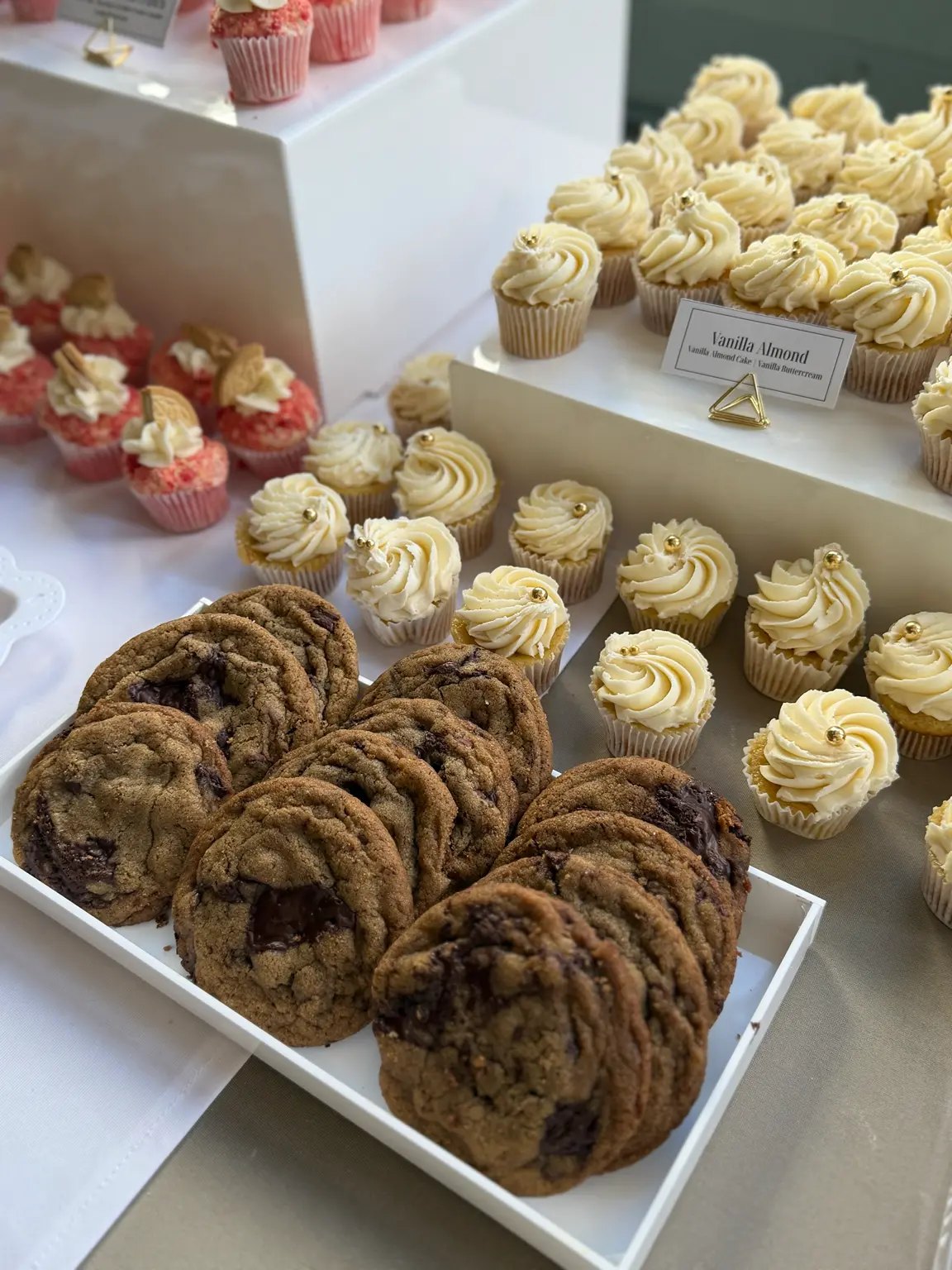 Event dessert table with cupcakes and cookies in several flavors