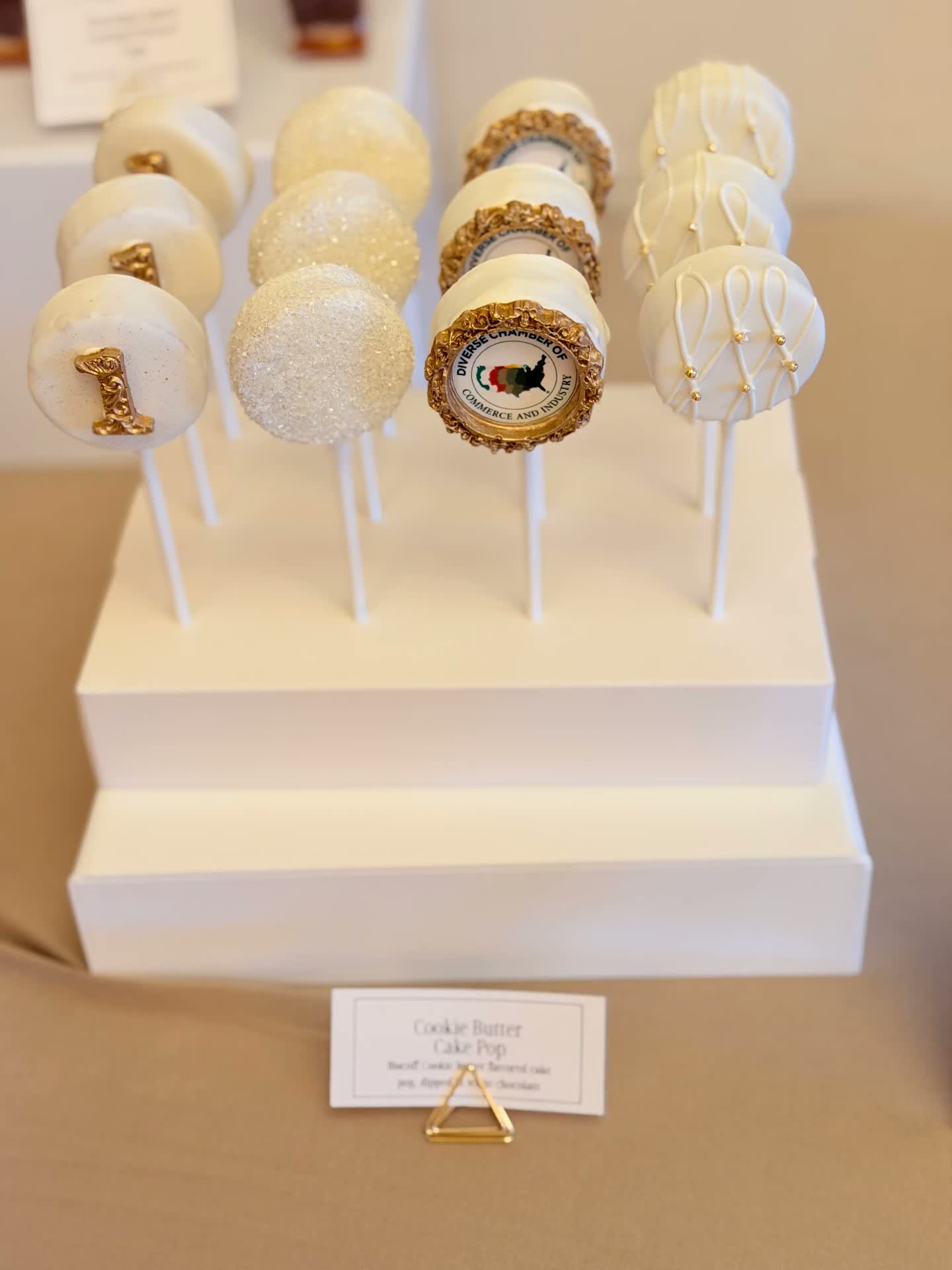 White and gold cake pops with edible images and pearl details