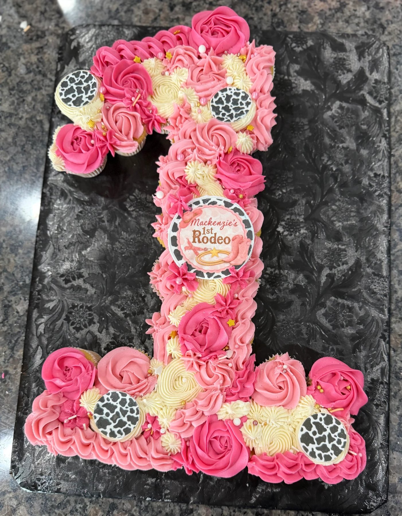 Pink rodeo-themed number one pull-apart cupcake cake