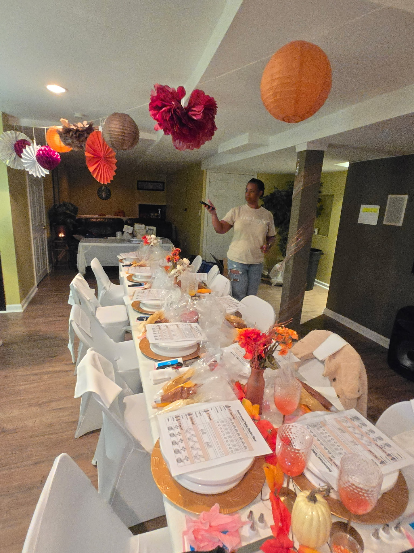 A decorating workshop setup with long tables, practice sheets and seasonal decor