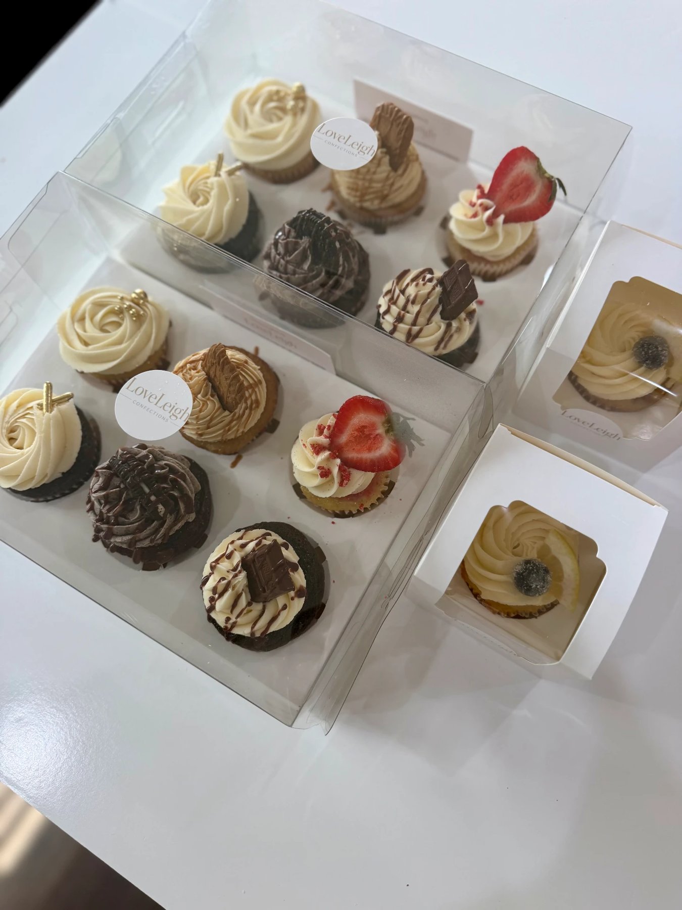 Two six-cupcake tasting boxes with two small cupcake boxes