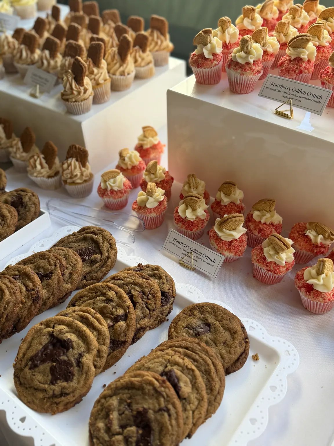 Strawberry Golden Crunch cupcakes and cookies on a celebration dessert table