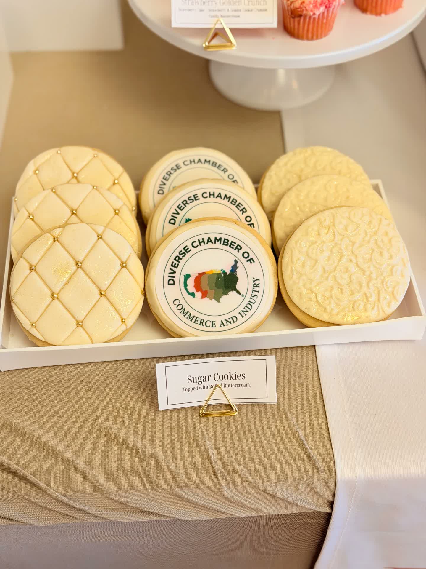 Sugar cookies with edible image logos and rolled buttercream designs