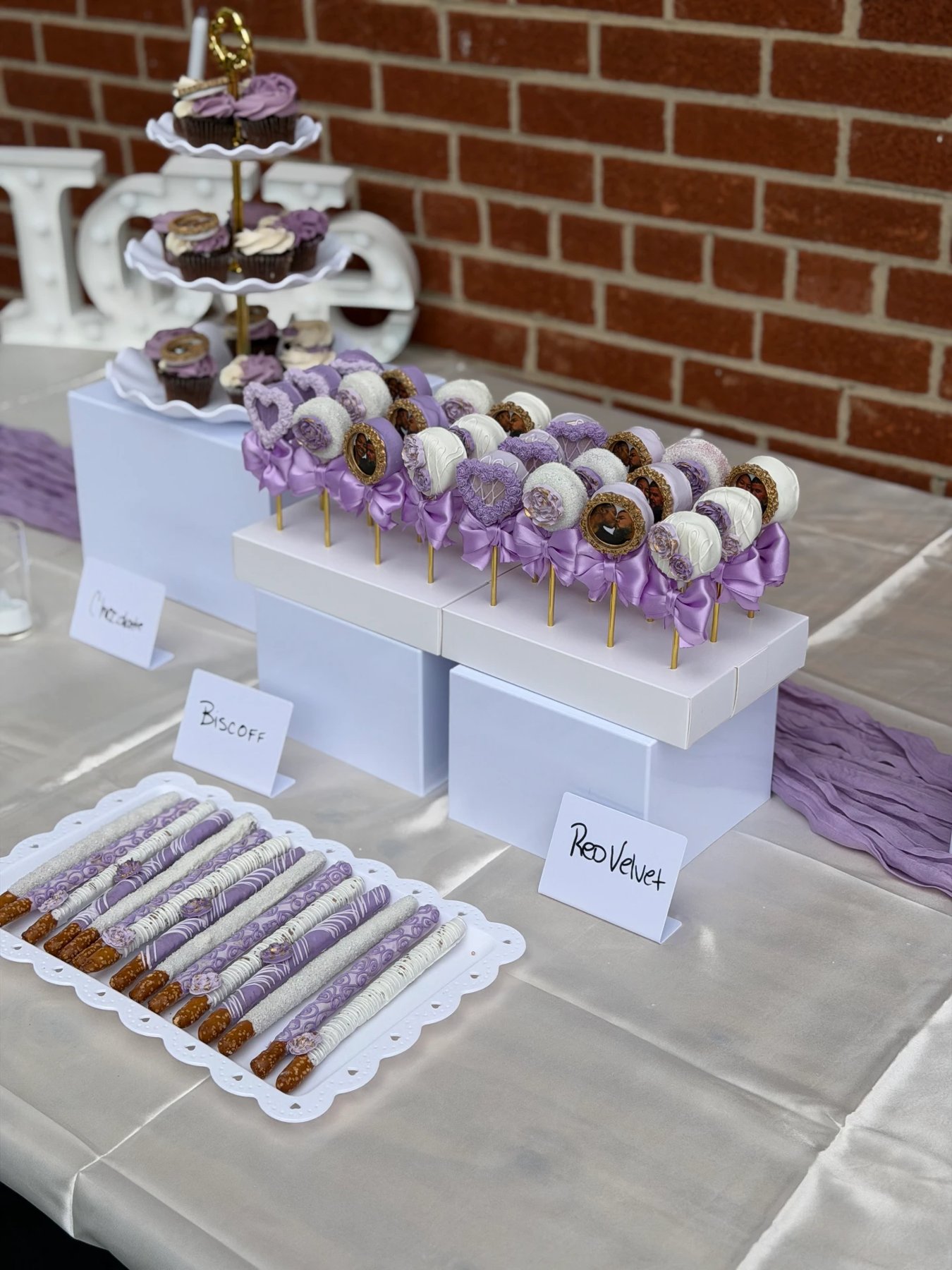 Lavender and white dessert tablescape with cake pops, pretzels and cupcakes