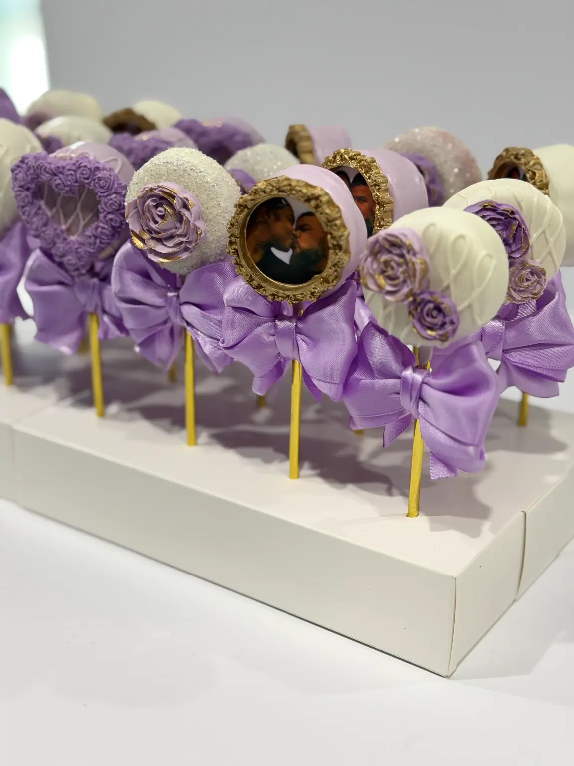 Lavender and white wedding cake pops with floral details