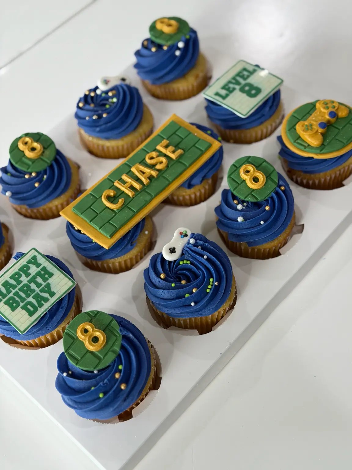 Blue and green gamer-themed birthday cupcakes