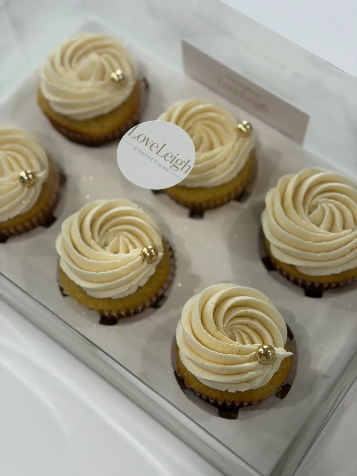 Vanilla buttercream cupcakes in a clear LoveLeigh gift box