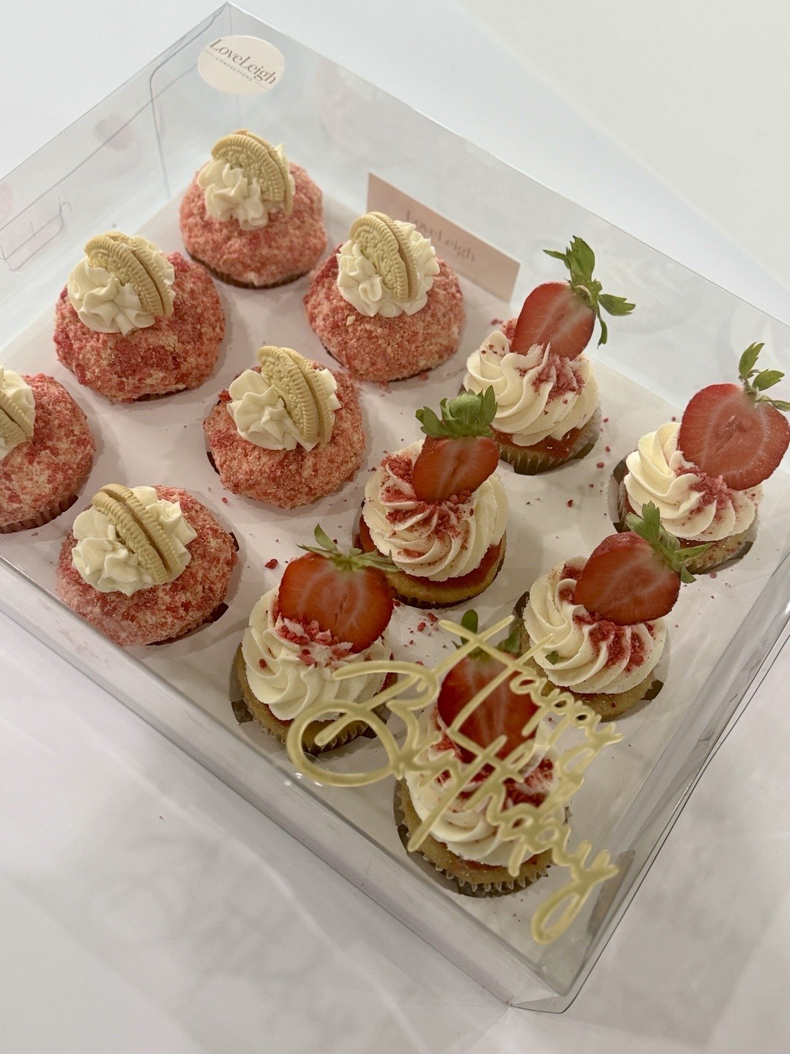 Strawberry cupcakes and strawberry crunch cake cups in a clear gift box
